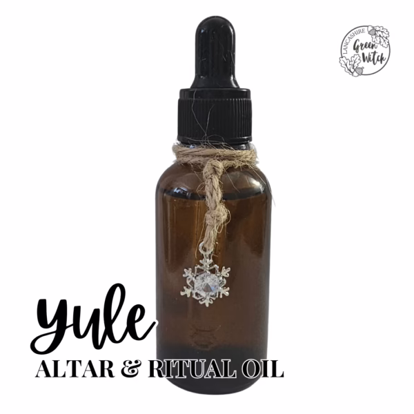 Yule Altar Oil with snowflake charm, frankincense, myrrh, and cedarwood in a winter solstice ritual blend
